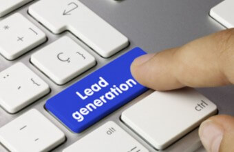 A person is typing the word lead generation on a keyboard.
