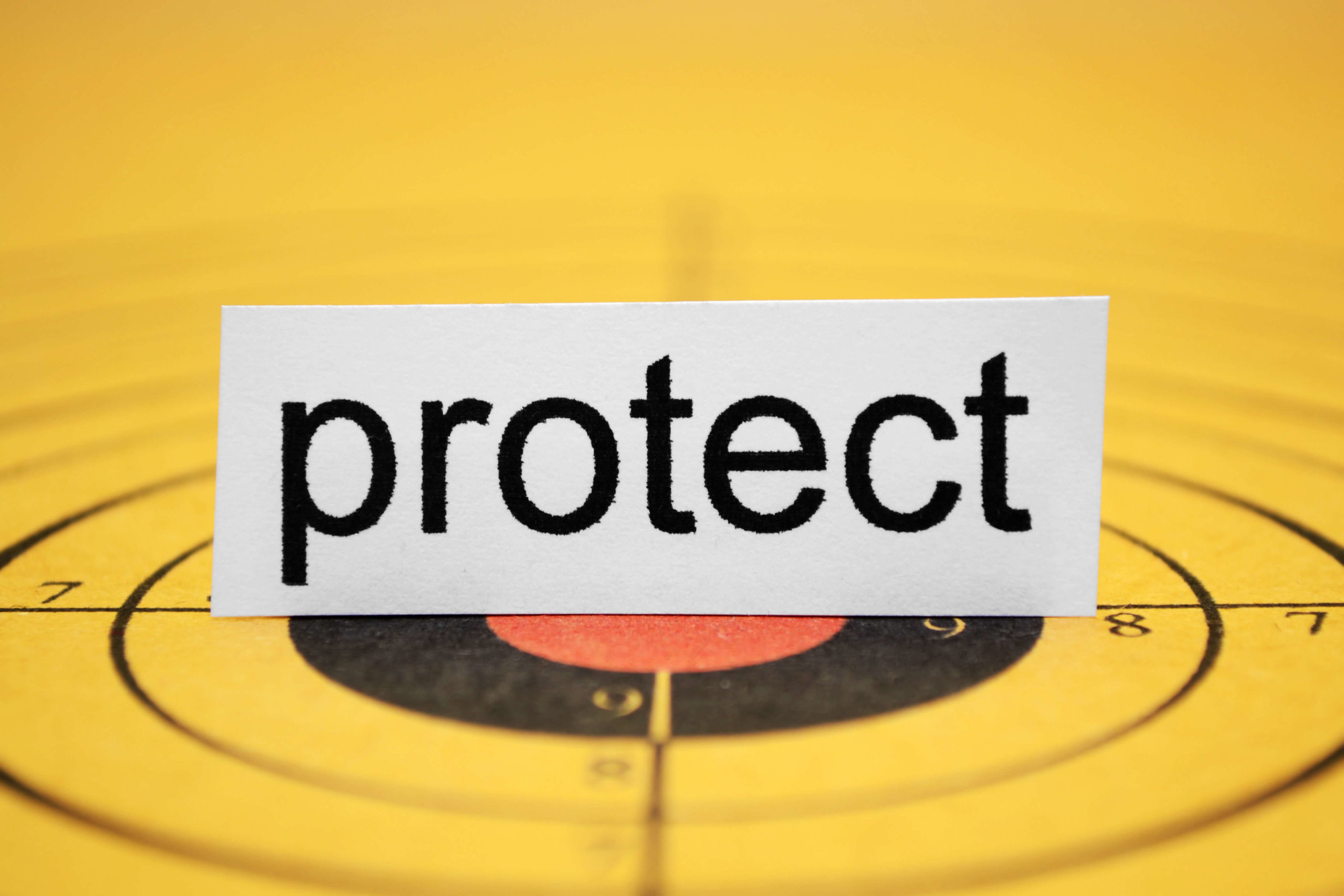 A sign with the word protect on top of a target.