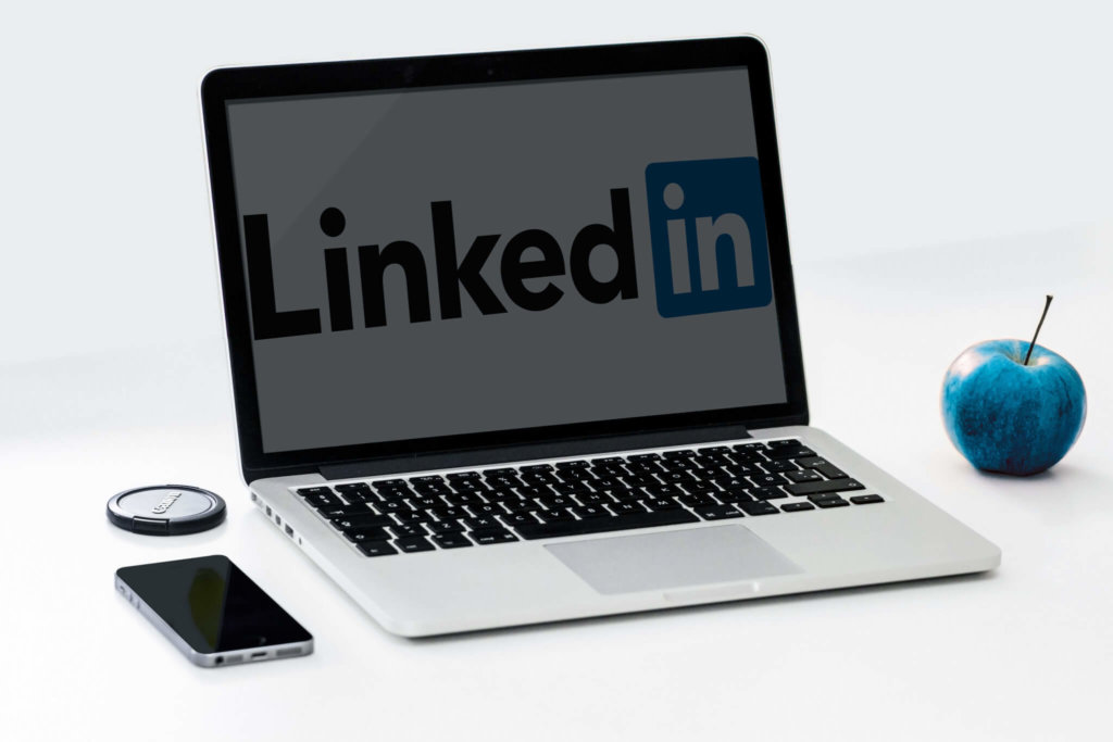 social selling vs. cold calling laptop with LinkedIn logo