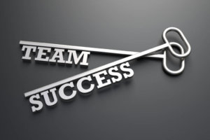 Two keys with the words team success on them.