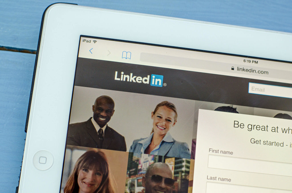 A white tablet displays the LinkedIn.com home page; time for a LinkedIn profile makeover.