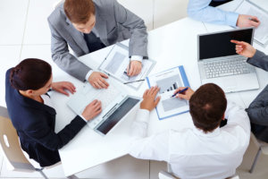 A group of people sitting around a table.