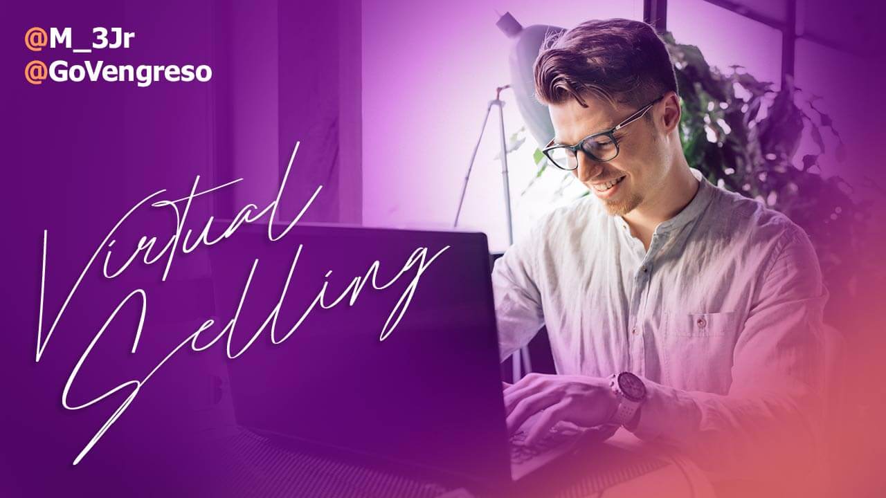 Virtual Selling Guide man with glasses sitting in front of laptop smiling
