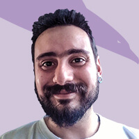 A member of our team with a beard against a purple background.