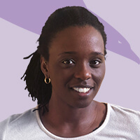 One of our team members, a woman with dreadlocks, smiling in front of a purple background.