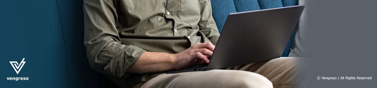 image of a man sitting working on his laptop