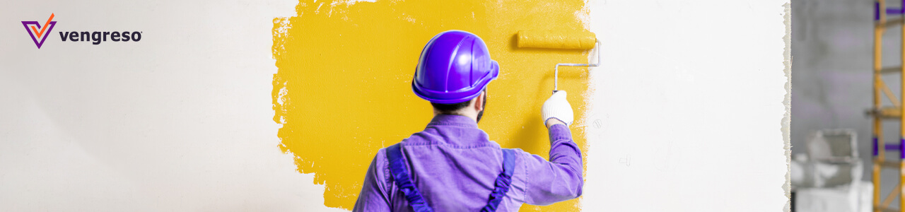 man with hard hat painting a wall with a roller color yellow as a linkeidn banner
