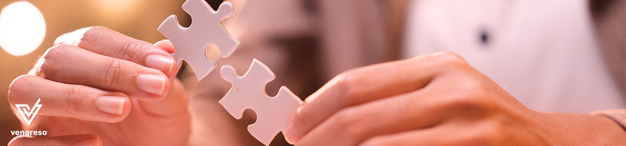 close up of hands holding up puzzle pieces for social media marketing