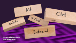 Image of five wooden keyboard shortcuts key replicas labeled "alt," "delete," "ctrl," "shift," and "enter" balanced on top of each other against a purple, wavy background. Two
