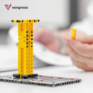 A person is using a lego to build a tower for their LinkedIn introduction.