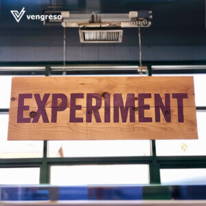A wooden sign that says experiment hanging from a window is showcased in a captivating LinkedIn post.
