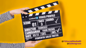 A person holding a clapper board with the words for a LinkedIn video profile.