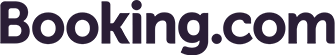 The image shows the logo of Booking.com, featuring the word "Booking" in bold, dark purple font followed by ".com" in a lighter blue font. The logo has a clean and modern design, representing the online travel agency known for booking accommodations and other travel services.