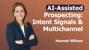 A woman with light brown hair in a navy blazer and white shirt stands smiling with folded arms. The text reads: "AI-Assisted Prospecting: Intent Signals & Multichannel. Hannah Willson" on a gradient orange background, highlighting intent signals.